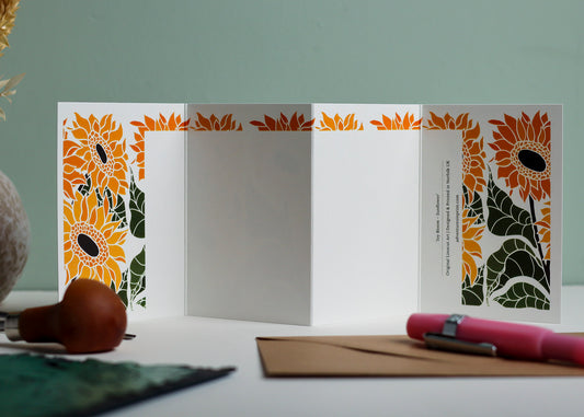 Reverse side of Joy Bloom Sunflower Garland card showing blank writing space. Hand-carved botanical design continues on back of concertina card, 300gsm recycled FSC certified cardstock, room for personal message.