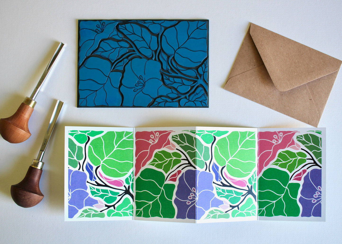 a colourful green, purple and pink repeat of a linocut morning glory flower