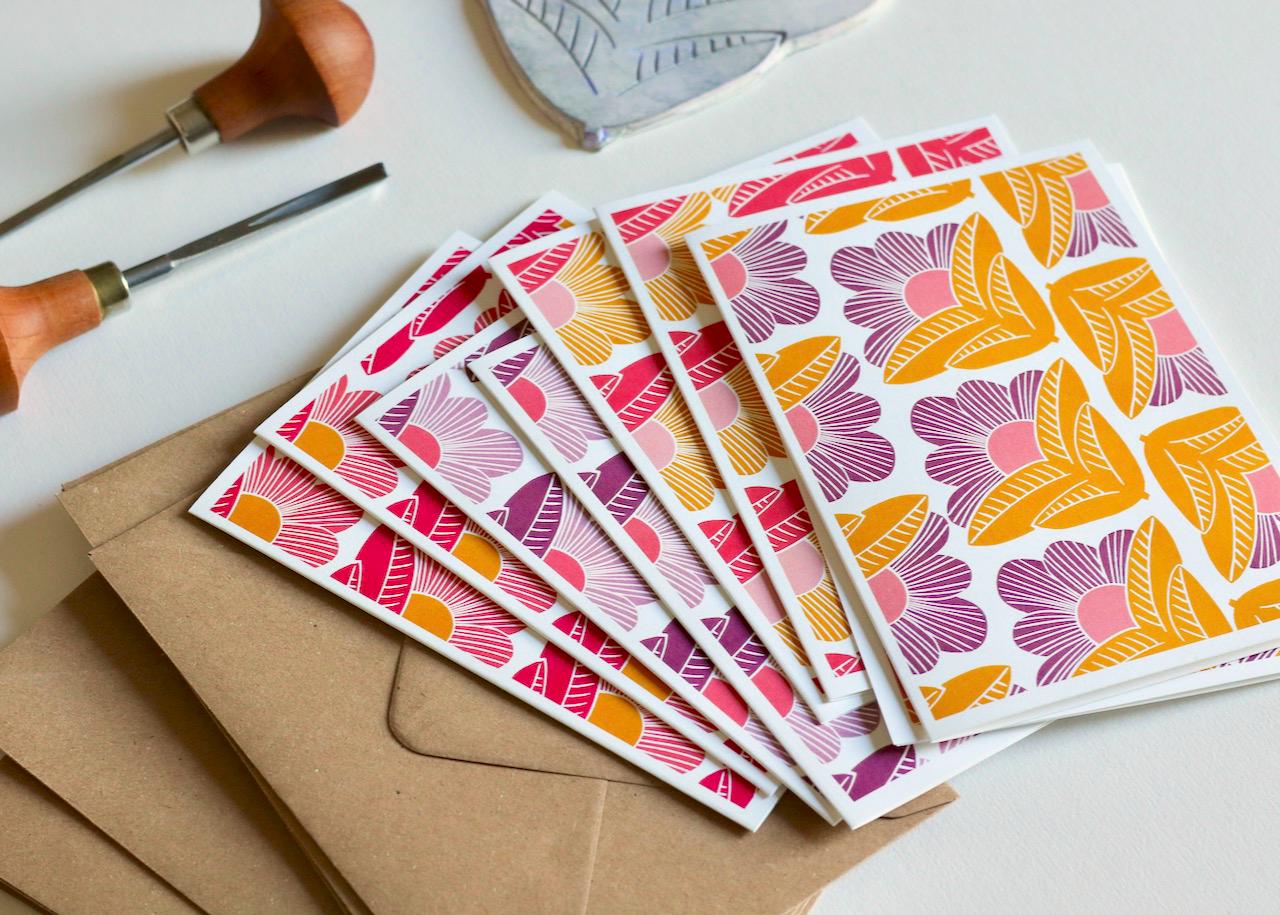 A6 sized notecard with original 'Sunrise Floral' linocut print alongside standard kraft envelope, demonstrating the perfect size for personal correspondence
