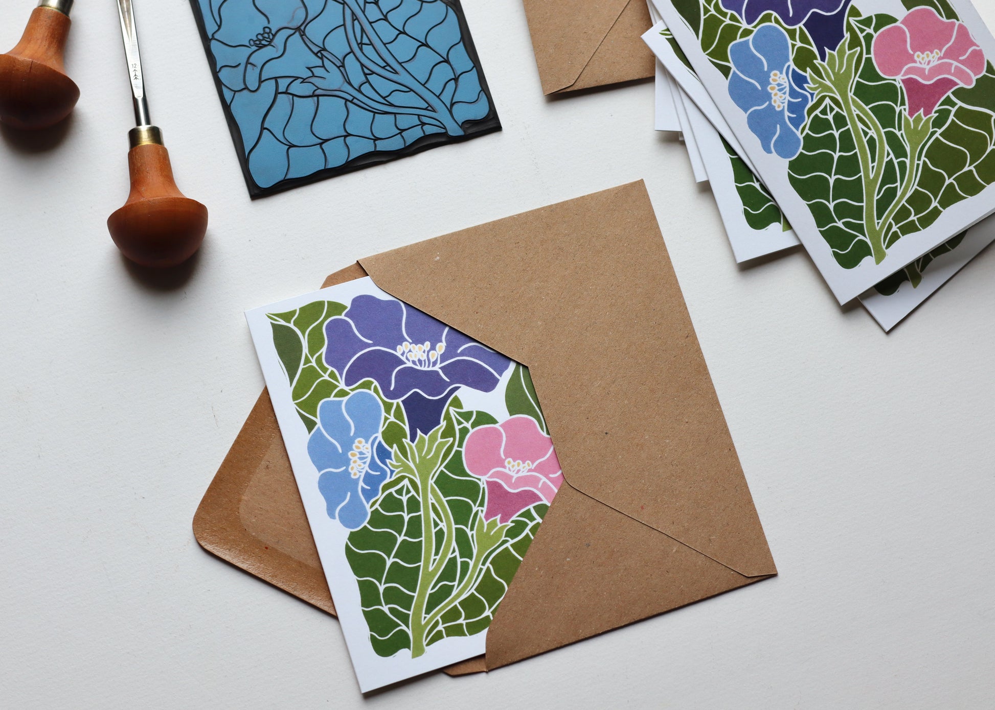 Hand-carved botanical notecards featuring bold graphic morning glory flowers in jewel tones with heart-shaped leaves