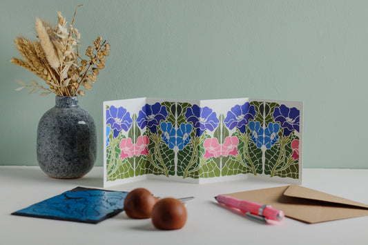 Morning Glory in Bloom botanical Garland card shown fully extended (105 x 297mm), displaying complete hand-carved linocut design. Modern cottagecore morning glory portrait in blue, pink and purple, perfect for mantlepiece display.