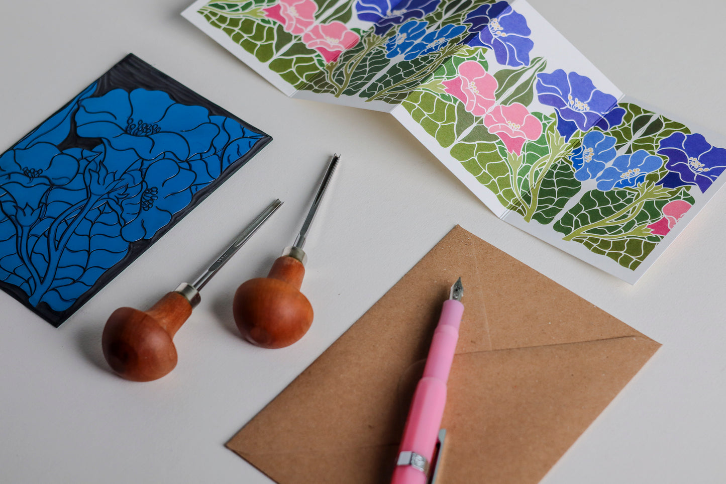 Morning Glory in Bloom Garland card featuring hand-carved linocut botanical portrait in blue, pink and purple. Double-sided concertina greeting card with bold, contemporary cottagecore design on eco-friendly recycled cardstock