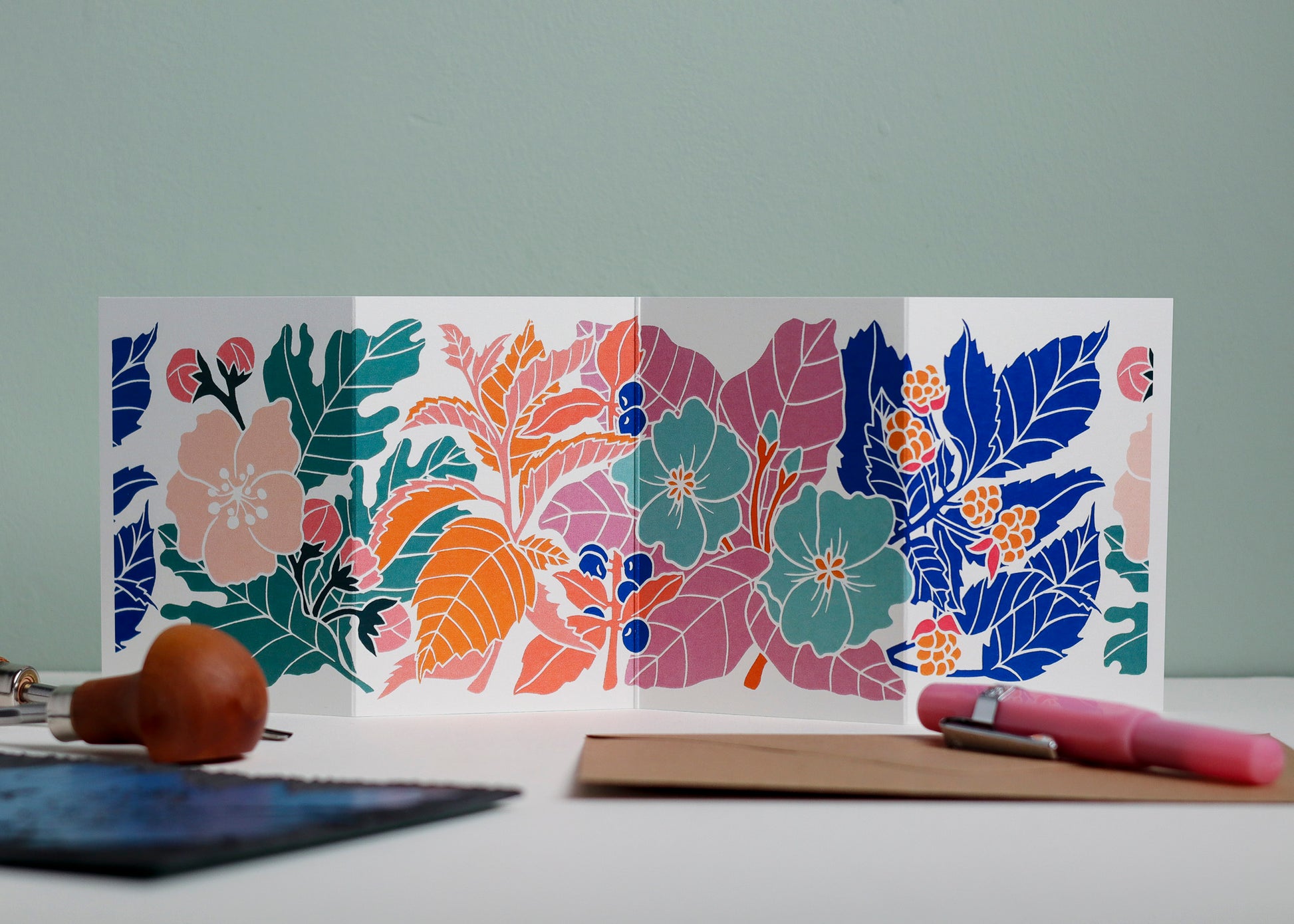 Happy Hedgerow Garland card featuring hand-carved linocut botanical portrait in modern colours. Double-sided concertina greeting card with bold, contemporary cottagecore design on eco-friendly recycled cardstock.