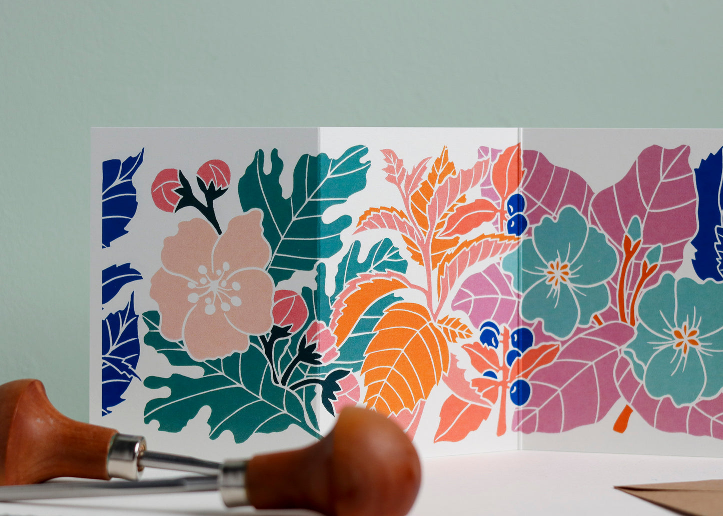 Close-up detail of hand-carved Happy Hedgerow design on Garland card. Bold  colours and graphic linocut linework showing botanical accuracy and contemporary colour palette inspired by Henri Rousseau and Frida Kahlo.