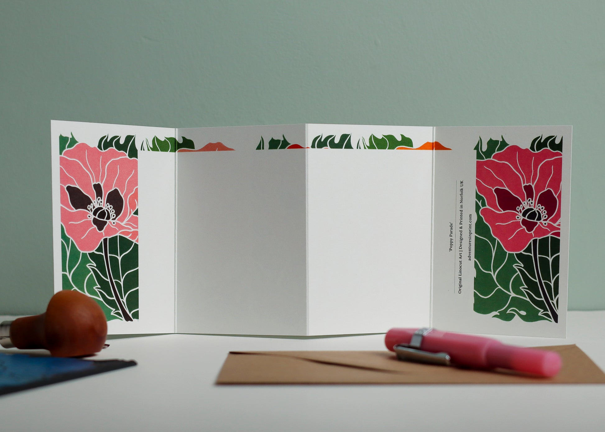 Reverse side of Poppy Parade Garland card showing blank writing space. Hand-carved botanical design continues on back of concertina card, 300gsm recycled FSC certified cardstock, room for personal message.