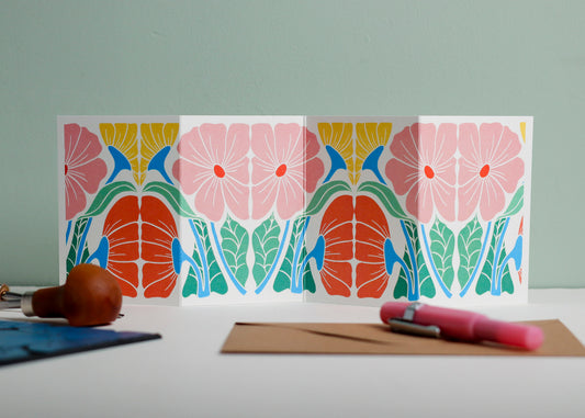 Bright & Beautiful Floral Garland card featuring hand-carved linocut botanical portrait in pink, red and yellow. Double-sided concertina greeting card with bold, contemporary cottagecore design on eco-friendly recycled cardstock.