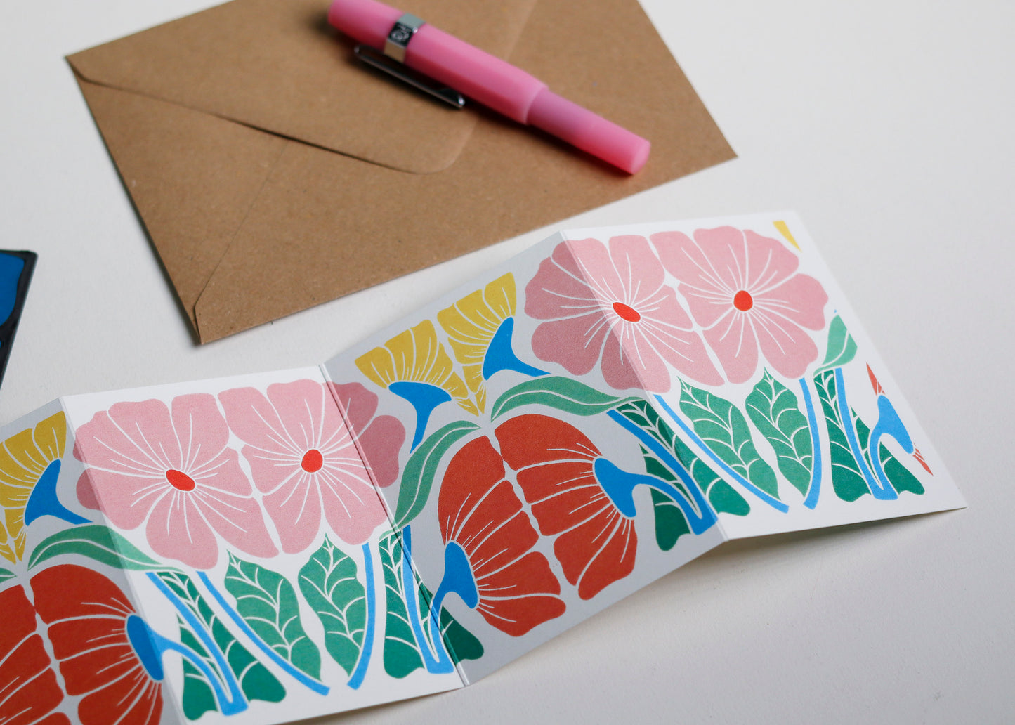 Bright & Beautiful Floral Garland card with C6 kraft envelope. Hand-carved botanical portrait greeting card on recycled cardstock, photographed with eco-friendly envelope, ready for posting.