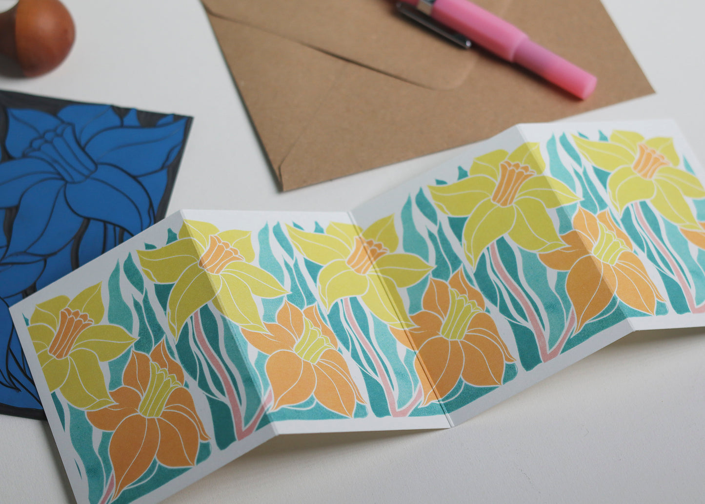 Close-up detail of hand-carved Welsh Daffodil design on Garland card. Bold yellows and orange and graphic linocut linework showing botanical accuracy and contemporary colour palette inspired by Henri Rousseau and Frida Kahlo.