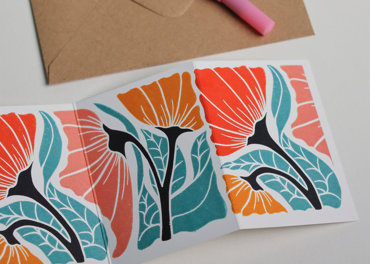 Happy Floral Garland card with C6 kraft envelope. Hand-carved botanical portrait greeting card on recycled cardstock, photographed with eco-friendly envelope, ready for posting.