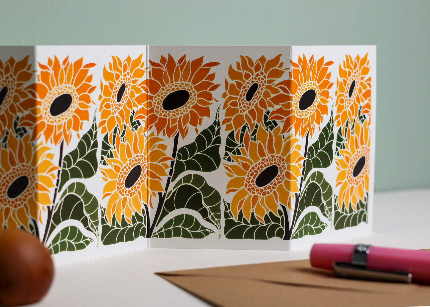 Close-up detail of hand-carved Joy Bloom Sunflower design on Garland card.