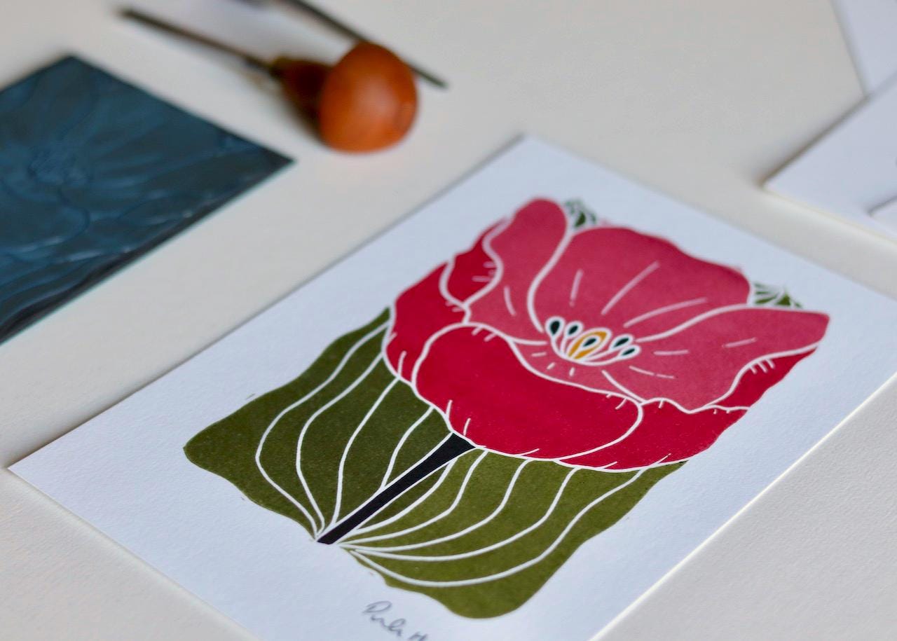 This art print features a romantic single tulip in a deep pink, created using traditional linocut techniques.