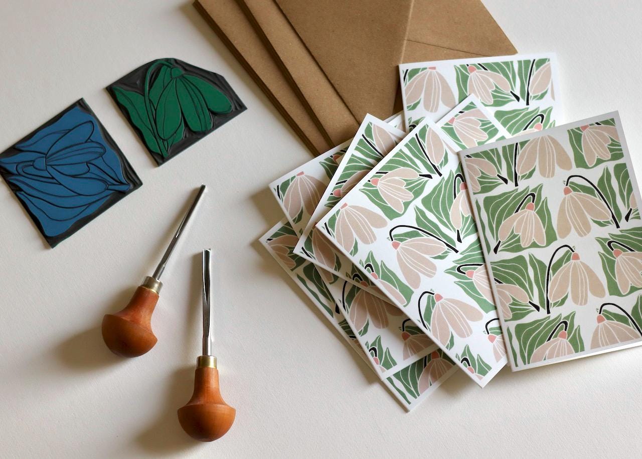 This set of note cards features a repeating winter snowdrop design in a soft green and off-white colour pattern.