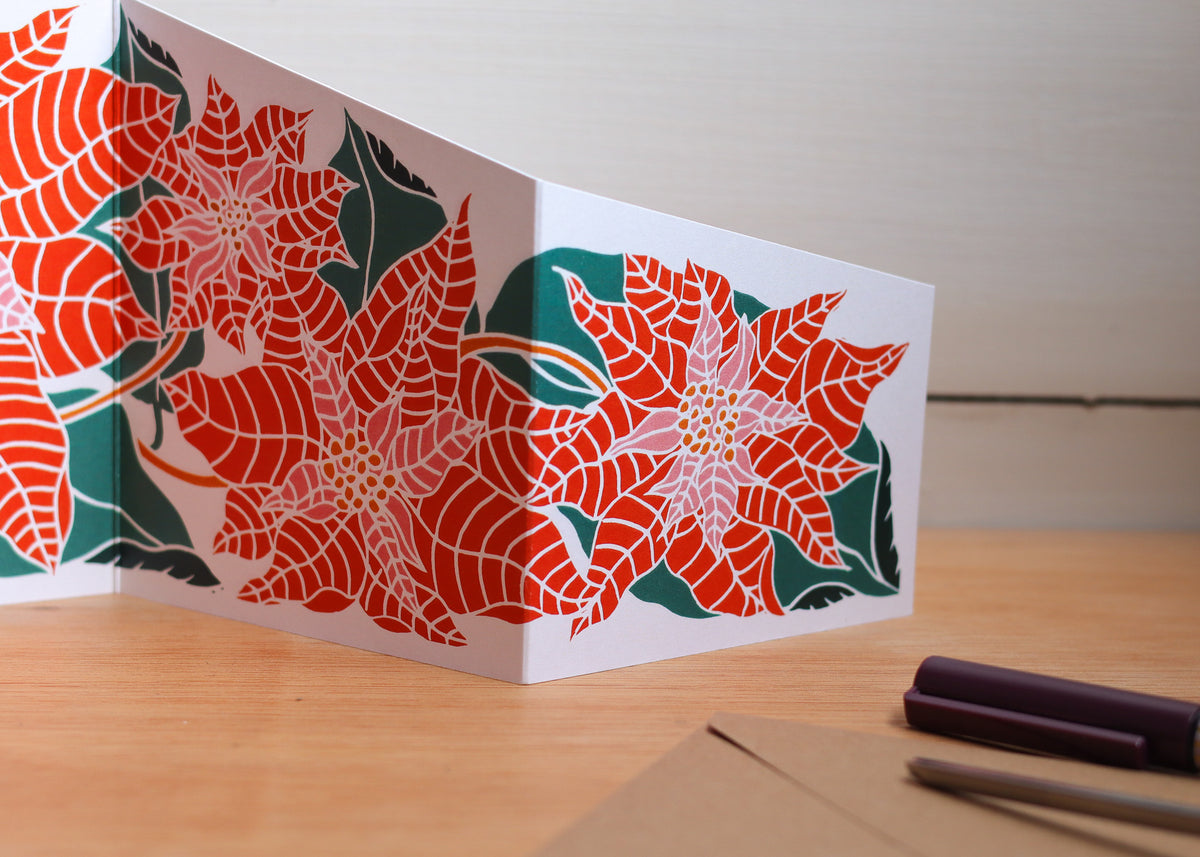 Close-up of hand-designed poinsettia print details and botanical leaf design